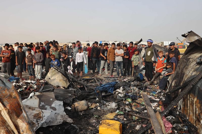 Palestinians gather at the site of an Israeli strike on a camp for internally displaced people in Rafah on 27 May, 2024, amid ongoing battles between Israel and the Palestinian Hamas militant group